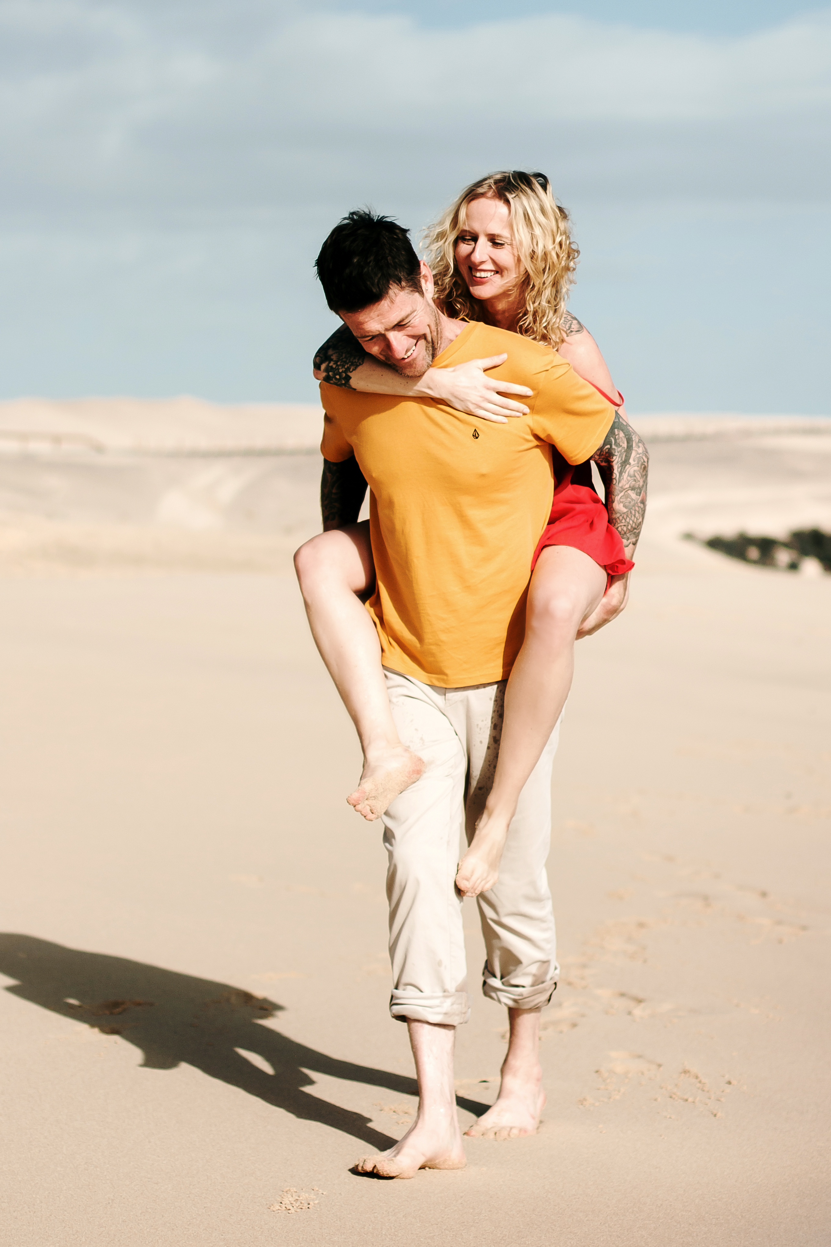 Fuerteventura beach photo shoot: Couple captured in stunning morning photo shoot on Grandes Playas - Dunes of Corralejo beach by professional photographer